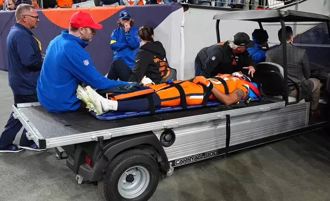 Denver Broncos wide receiver Pat Bryant is carted off the field after an injury during the second half of an NFL football game against the Jacksonville Jaguars in Denver, Sunday, Dec. 21, 2025. (AP Photo/Jack Dempsey)