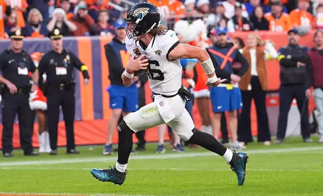 Jacksonville Jaguars quarterback Trevor Lawrence runs for a touchdown against the Denver Broncos during the second half of an NFL football game in Denver, Sunday, Dec. 21, 2025. (AP Photo/David Zalubowski)