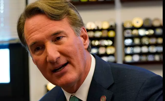 Virginia Gov. Glenn Youngkin gestures during an interview in his office at the Capitol Wednesday Dec. 10, 2025, in Richmond, Va. (AP Photo/Steve Helber)