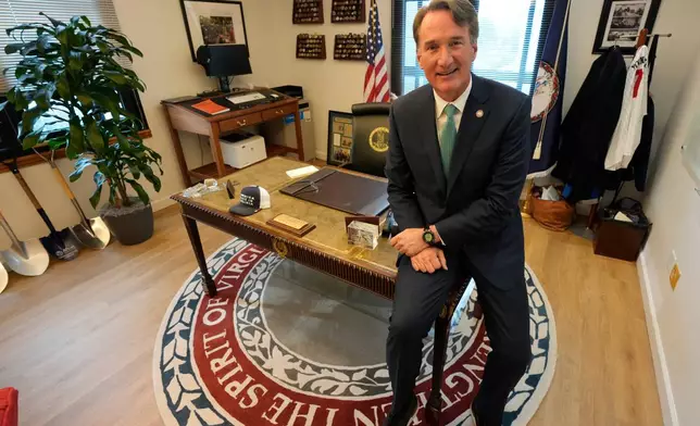Virginia Gov. Glenn Youngkin gestures during an interview in his office at the Capitol Wednesday Dec. 10, 2025, in Richmond, Va. (AP Photo/Steve Helber)