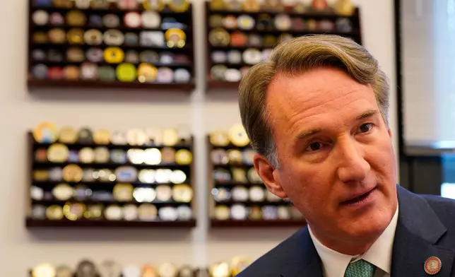 Virginia Gov. Glenn Youngkin gestures during an interview in his office at the Capitol Wednesday Dec. 10, 2025, in Richmond, Va. (AP Photo/Steve Helber)