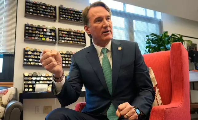 Virginia Gov. Glenn Youngkin gestures during an interview in his office at the Capitol Wednesday Dec. 10, 2025, in Richmond, Va. (AP Photo/Steve Helber)