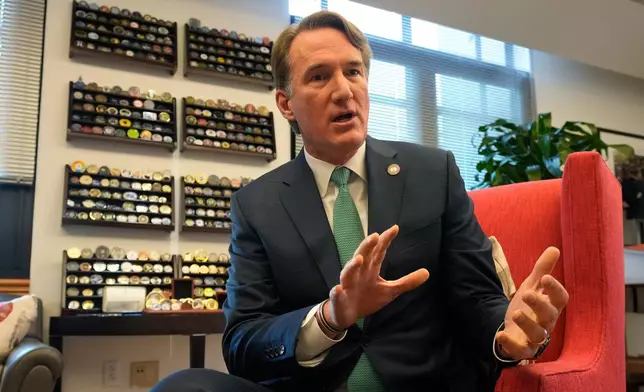 Virginia Gov. Glenn Youngkin gestures during an interview in his office at the Capitol Wednesday Dec. 10, 2025, in Richmond, Va. (AP Photo/Steve Helber)
