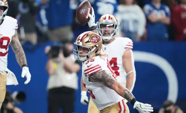 San Francisco 49ers tight end George Kittle, foreground, celebrates after scoring against the Indianapolis Colts during the first half of an NFL football game, Monday, Dec. 22, 2025, in Indianapolis. (AP Photo/AJ Mast)