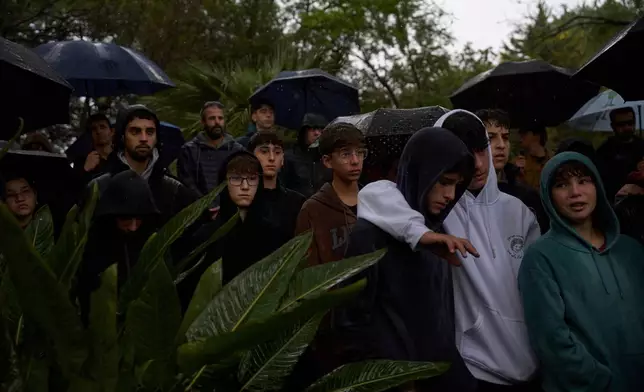 Mourners gather for the funeral of Aviv Maor, 19, an Israeli who killed by a Palestinian attacker last week, at kibbutz ein harod cemetery in northern Israel on Monday, Dec 29, 2025. (AP Photo/Ohad Zwigenberg)
