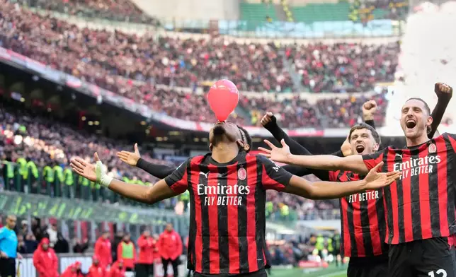 AC Milan's Christopher Nkunku celebrates after scoring his side's second goal from a penalty kick during a Serie A soccer match between AC Milan and Hellas Verona, in Milan, Italy, Sunday, Dec. 28, 2025. (AP Photo/Luca Bruno)