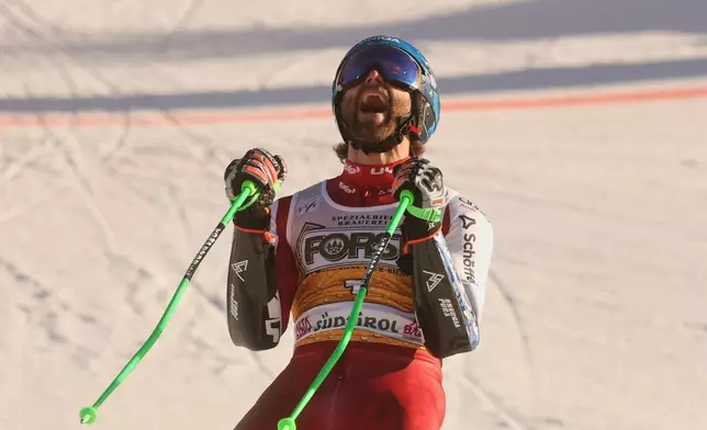 Austria's Marco Schwarz celebrates at the finish area of an alpine ski, men's World Cup Giant slalom, in Alta Badia, Italy, Sunday Dec. 21, 2025. (AP Photo/Alessandro Trovati)