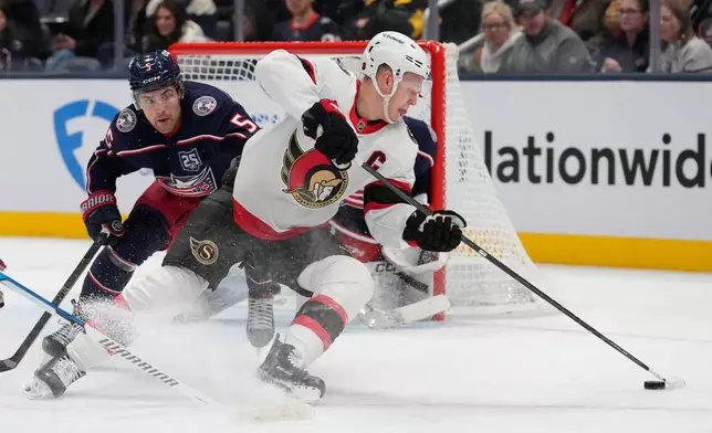 Ottawa Senators left wing Brady Tkachuk, right, skates in front of Columbus Blue Jackets defenseman Denton Mateychuk (5) in the second period of an NHL hockey game Thursday, Dec. 11, 2025, in Columbus, Ohio. (AP Photo/Sue Ogrocki)