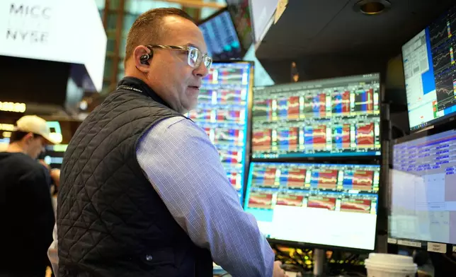 Anthony Matesic works on the floor at the New York Stock Exchange in New York, Wednesday, Dec. 10, 2025. (AP Photo/Seth Wenig)