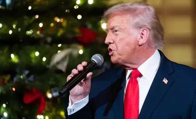 President Donald Trump speaks before a concert by Andrea Bocelli in the East Room of the White House walking towards the East Room, Friday, Dec. 5, 2025, in Washington. (AP Photo/Allison Robbert)