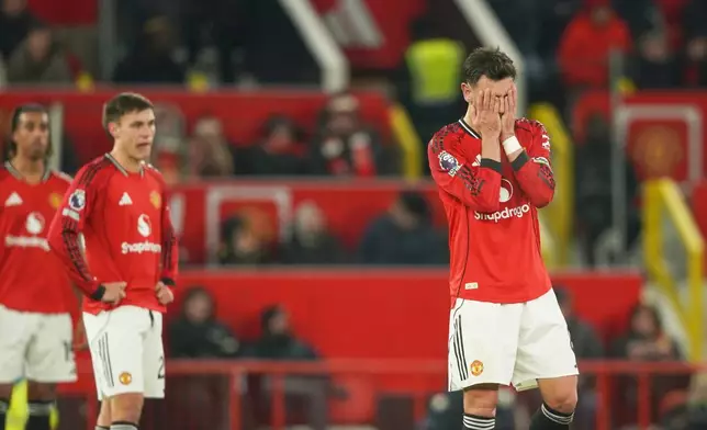 Manchester United's Bruno Fernandes, right, reacts after West Ham's Soungoutou Magassa scored his side's first goal during the English Premier League soccer match between Manchester United and West Ham United in Manchester, England, Thursday, Dec. 4, 2025. (AP Photo/Ian Hodgson)