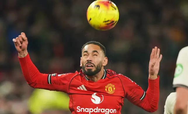 Manchester United's Matheus Cunha heads the ball during the English Premier League soccer match between Manchester United and West Ham United in Manchester, England, Thursday, Dec. 4, 2025. (AP Photo/Ian Hodgson)