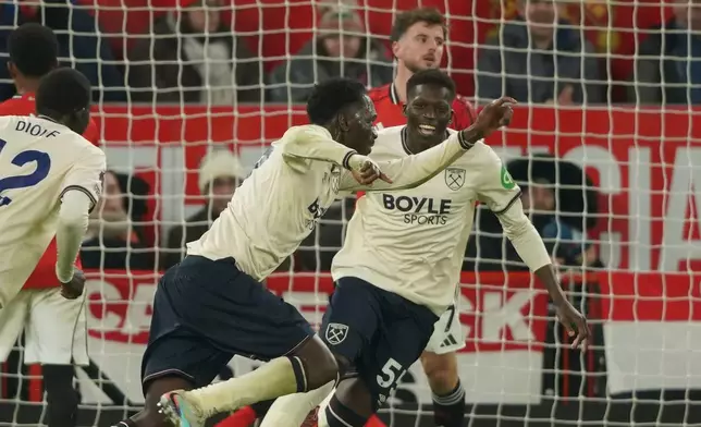 West Ham's Soungoutou Magassa, centre, celebrates after scoring his side's opening goal during the English Premier League soccer match between Manchester United and West Ham United in Manchester, England, Thursday, Dec. 4, 2025. (AP Photo/Ian Hodgson)