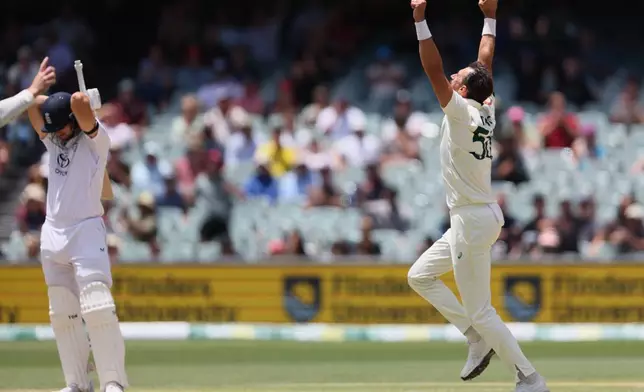 Australia's Mitchell Starc, right, celebrates the wicket of England's Will Jacks, left, during play on the final day of the third Ashes cricket test between England and Australia in Adelaide, Australia, Sunday, Dec. 21, 2025. (AP Photo/James Elsby)