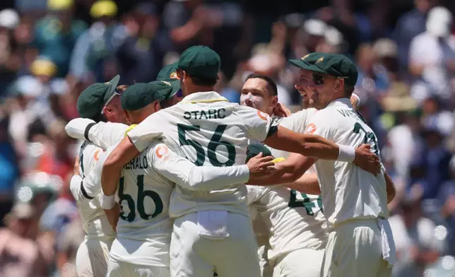 Australia's players celebrate after winning the third Ashes Test against England in Adelaide, Australia, Sunday, Dec. 21, 2025. (AP Photo/James Elsby)