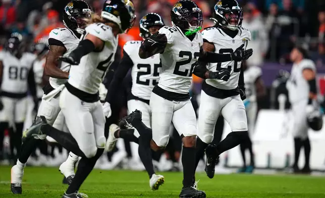 Jacksonville Jaguars cornerback Jarrian Jones (22) celebrates after intercepting a pass against the Denver Broncos during the second half of an NFL football game in Denver, Sunday, Dec. 21, 2025. (AP Photo/Jack Dempsey)