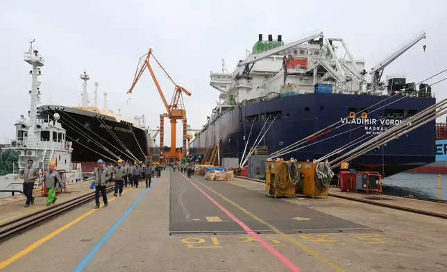 FILE - Workers walk past large-sized liquefied natural gas (LNG) carriers under construction at the Daewoo Shipbuilding and Marine Engineering facility in Geoje Island, South Korea, Dec. 7, 2018. (AP Photo/Ahn Young-joon, File)