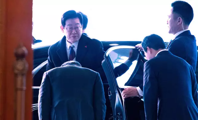 South Korean President Lee Jae Myung, left, arrives at the presidential office Cheong Wa Dae, or the Blue House in Seoul, Monday, Dec. 29, 2025 as Lee marked his first official day at Cheong Wa Dae on Monday after three years and seven months since the Yoon Seok-yeol government moved the presidential office to Yongsan in May 2022. (Jeoon Heon-Kyun/Pool Photo via AP)