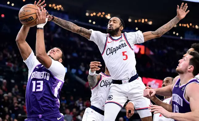 Sacramento Kings forward Keegan Murray (13) has his shot blocked by Los Angeles Clippers forward Derrick Jones Jr. (5) in the first half of an NBA basketball game Tuesday, Dec. 30, 2025, in Inglewood, Calif. (AP Photo/Wally Skalij)