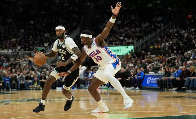 Milwaukee Bucks' Bobby Portis (9) drives to the basket against Philadelphia 76ers' Adem Bona (30) during the first half of an NBA basketball game Friday, Dec. 5, 2025, in Milwaukee. (AP Photo/Aaron Gash)