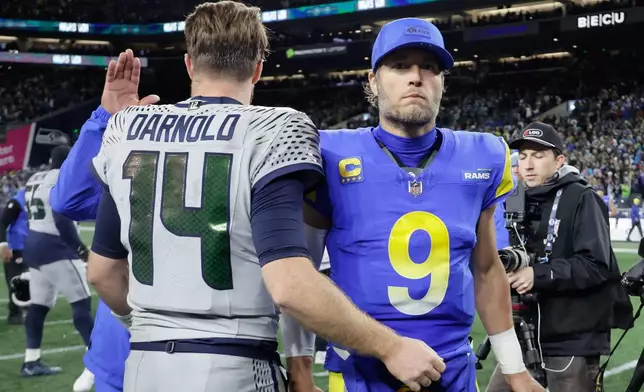 Seattle Seahawks quarterback Sam Darnold (14) greets Los Angeles Rams quarterback Matthew Stafford (9) after an NFL football game Thursday, Dec. 18, 2025, in Seattle. (AP Photo/John Froschauer)