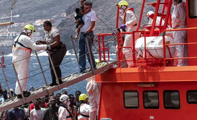 FILE - Migrants disembark at the port of "La Estaca" in Valverde at the Canary island of El Hierro, Spain, Monday, Aug. 26, 2024. (AP Photo/Maria Ximena, File)