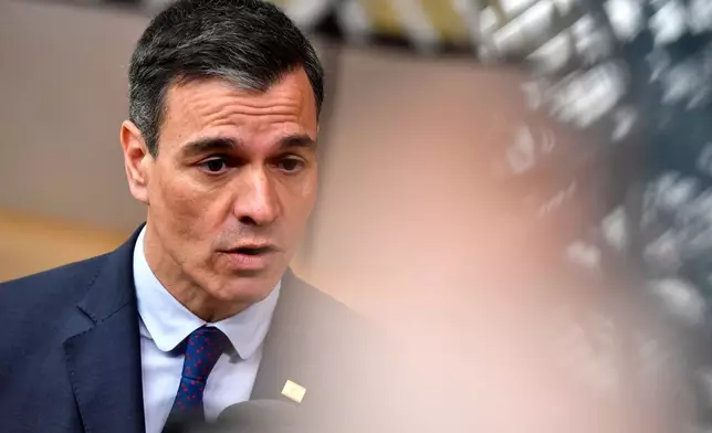 FILE - Spain's Prime Minister Pedro Sanchez speaks with the media as he arrives for an EU summit at the European Council building in Brussels, Thursday, March 23, 2023. (AP Photo/Geert Vanden Wijngaert, File)