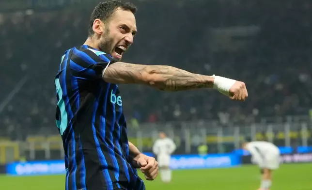 Inter Milan's Hakan Calhanoglu celebrates after scoring his side's third goal during a Serie A soccer match between Inter and Como, in Milan, Italy, Saturday, Dec. 6, 2025. (AP Photo/Luca Bruno)