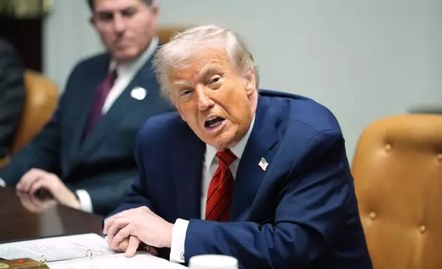 Sitting next to founder and CEO of Dell, Michael Dell, left, President Donald Trump speaks during a roundtable discussion with business leaders in the Roosevelt Room of the White House, Wednesday, Dec. 10, 2025, in Washington. (AP Photo/Evan Vucci)