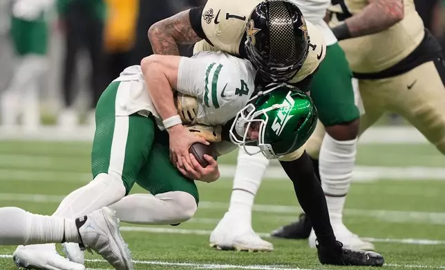 New Orleans Saints cornerback Alontae Taylor (1) sacks New York Jets quarterback Brady Cook during the second half of an NFL football game Sunday, Dec. 21, 2025, in New Orleans. (AP Photo/Gerald Herbert)