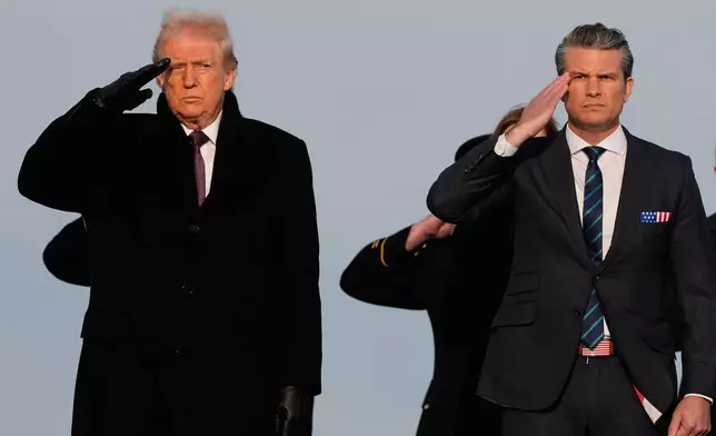 President Donald Trump and Defense Secretary Pete Hegseth salute as carry teams move the transfer cases with the remains of Iowa National Guard soldiers Sgt. William Nathaniel Howard, 29, of Marshalltown, Iowa, and Sgt. Edgar Brian Torres-Tovar, 25, of Des Moines, Iowa, and civilian interpreter Ayad Mansoor Sakat, who were killed in an attack in Syria, during a casualty return, Wednesday, Dec. 17, 2025 at Dover Air Force Base, Del. (AP Photo/Julia Demaree Nikhinson)