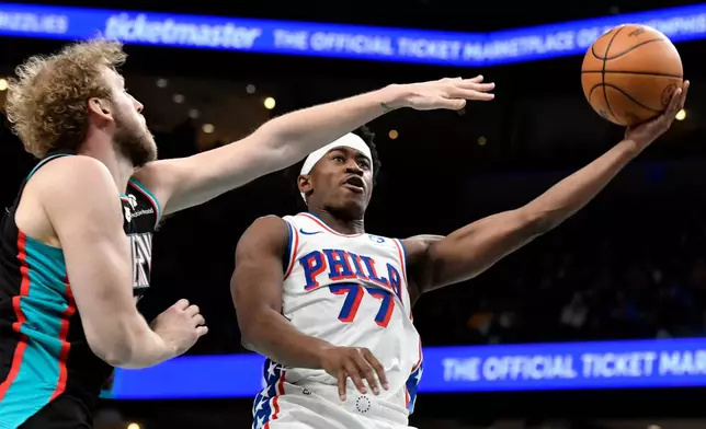 Philadelphia 76ers guard VJ Edgecombe (77) shoots against Memphis Grizzlies center Jock Landale in the second half of an NBA basketball game Tuesday, Dec. 30, 2025, in Memphis, Tenn. (AP Photo/Brandon Dill)