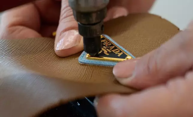 A leather good operator works at the Prada factory in Scandicci, Italy, Friday, Nov. 28, 2025. (AP Photo/Gregorio Borgia, File)