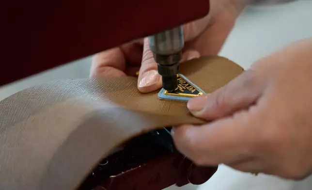 A leather good operator works at the Prada factory in Scandicci, Italy, Friday, Nov. 28, 2025. (AP Photo/Gregorio Borgia)