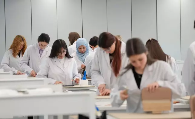 Leather good trainees work at the Prada factory in Scandicci, Italy, Friday, Nov. 28, 2025. (AP Photo/Gregorio Borgia)