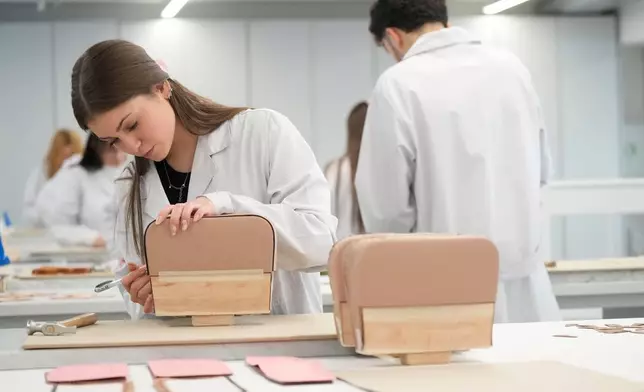 Leather good trainees work at the Prada factory in Scandicci, Italy, Friday, Nov. 28, 2025. (AP Photo/Gregorio Borgia)
