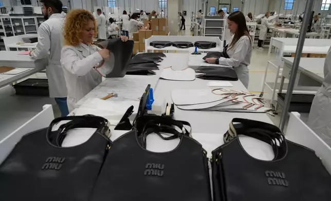 Leather good operators work at the Prada factory in Scandicci, Italy, Friday, Nov. 28, 2025. (AP Photo/Gregorio Borgia)