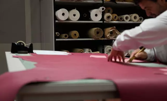 A leather good operator works at the Prada factory in Scandicci, Italy, Friday, Nov. 28, 2025. (AP Photo/Gregorio Borgia)