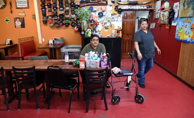 Armando Martinez, left, and his wife, Maria Dolores Perez, right, work in their restaurant, Los Jalapenos, near the Tyson Foods' beef plant in Lexington, Neb., Wednesday, Dec. 3, 2025. (AP Photo/Thomas Peipert)