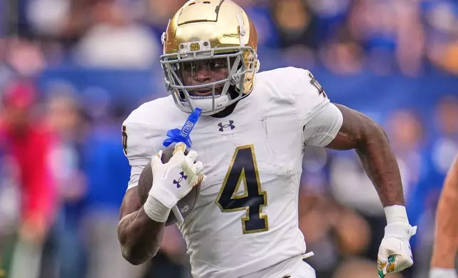 FILE - Notre Dame running back Jeremiyah Love (4) carries the ball during the first half of an NCAA college football game against Pittsburgh in Pittsburgh Saturday, Nov. 15, 2025. (AP Photo/Gene J. Puskar, File)