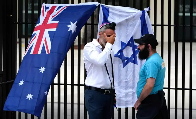 Alex Ryvchin, left, Co-Chief of the Executive Council of Australian Jewry, reacts outside Bondi Pavilion at Sydney's Bondi Beach, Monday, Dec. 15, 2025, a day after a shooting. (AP Photo/Mark Baker)
