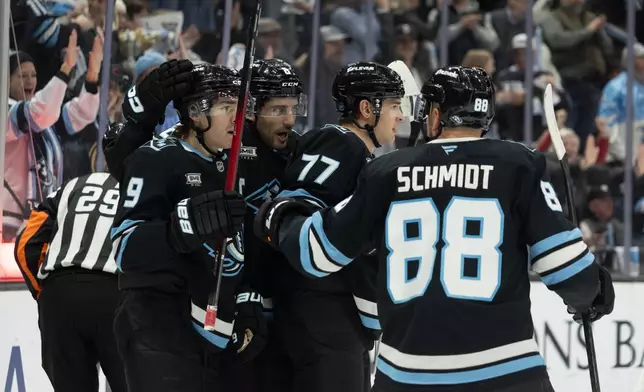 Utah Mammoth celebrate right wing JJ Peterka's (77) goal against the Winnipeg Jets during the first period of an NHL hockey game, Sunday, Dec. 21, 2025, in Salt Lake City. (AP Photo/Melissa Majchrzak)
