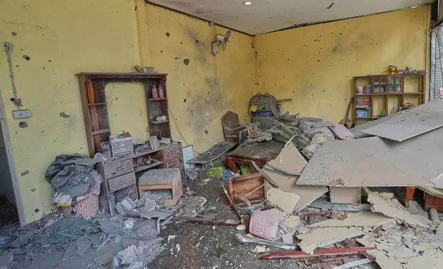 This shows a house which, Thai local security forces say, was damaged by a Cambodian artillery in Surin province, Thailand, Thursday, Dec. 11, 2025. (AP Photo/Sakchai Lalit)