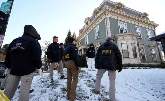 Members of the FBI Evidence Response Team search for evidence near the campus of Brown University, Monday, Dec. 15, 2025, in Providence, R.I. (AP Photo/Robert F. Bukaty)