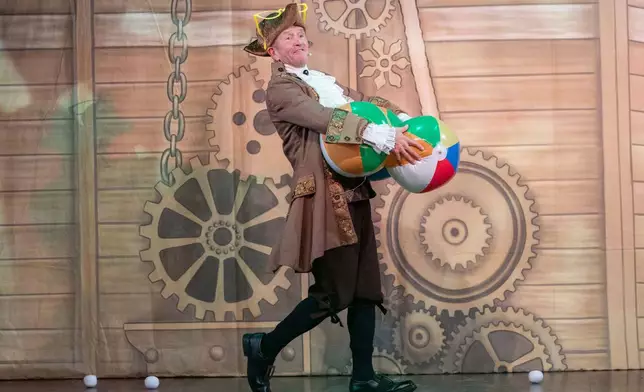 Michael Edwards, better known as Eddie the Eagle, plays Professor Crackpot in the pantomime "Beauty and the Beast" at Watersmeet Theatre, in Rickmansworth, England, Dec. 5, 2025. (AP Photo/Thomas Krych)