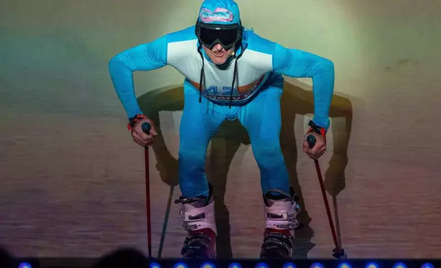 Michael Edwards, better known as Eddie the Eagle plays Professor Crackpot in the pantomime "Beauty and the Beast" at Watersmeet Theatre in Rickmansworth, England, Dec. 5 2025. (AP Photo/Thomas Krych)