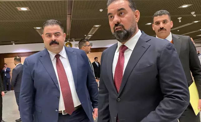 The new speaker of parliament Haibet Al-Halbousi, center, looks on before the start of their first legislative session in Baghdad, Iraq, Monday, Dec. 29, 2025. (AP Photo/Hadi Mizban)