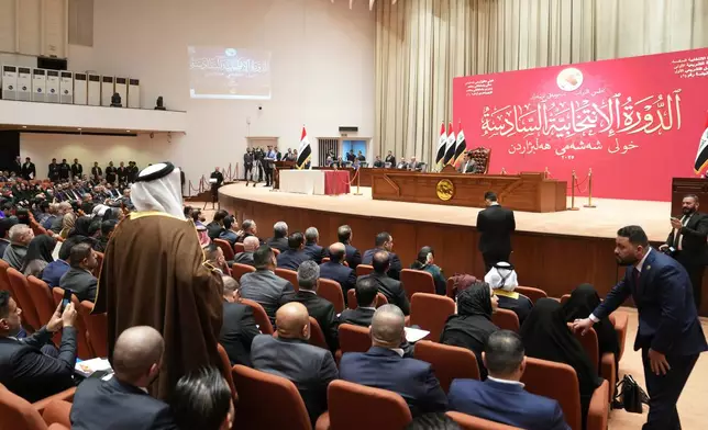 Newly elected lawmakers attend the first parliament session, in Baghdad, Iraq, Monday, Dec. 29, 2025. (Iraqi Parliament Media Office via AP)