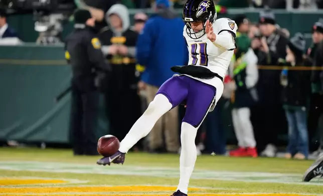 Baltimore Ravens punter Jordan Stout (11) warms up before an NFL football game against the Green Bay Packers, Saturday, Dec. 27, 2025, in Green Bay, Wis. (AP Photo/Morry Gash)