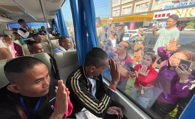 In this photo released by Agence Kampuchea Press (AKP), Cambodian soldiers are welcomed by villagers upon their arrival at Prum border gate, in Pailin province, Cambodia, Wednesday, Dec. 31, 2025, after being captured and held by Thailand. (AKP via AP)